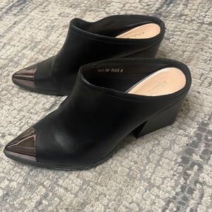 Black Steel toe mules.